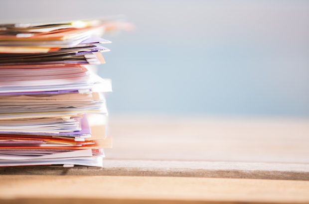 A pile of papers on a desk, indicating the paperwork involved with a Type 1B variation