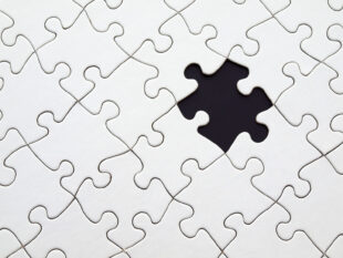 grey jigsaw with one piece missing